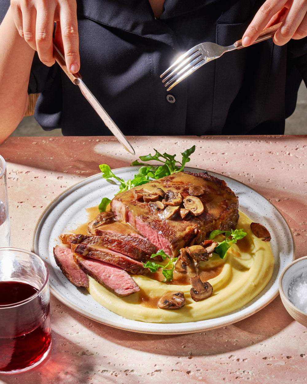 Seared steak with mushrooms on creamy miso butter mashed potatoes, served with greens