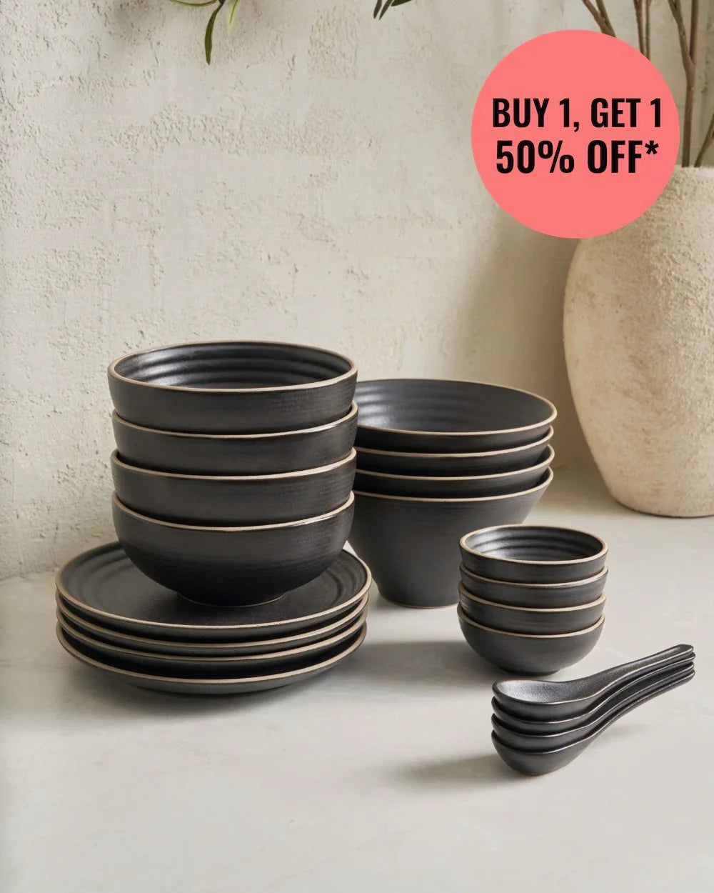 Asoke charcoal black stoneware noodle set with bowls, plates, and spoons on beige surface, buy 1 get 50% off