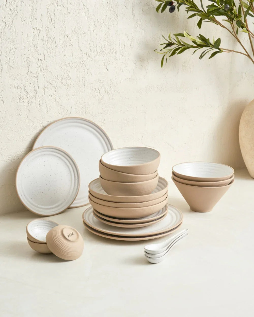Anaya dinnerware set from Asoke by Marion Grasby with beige and white plates, bowls, and spoons