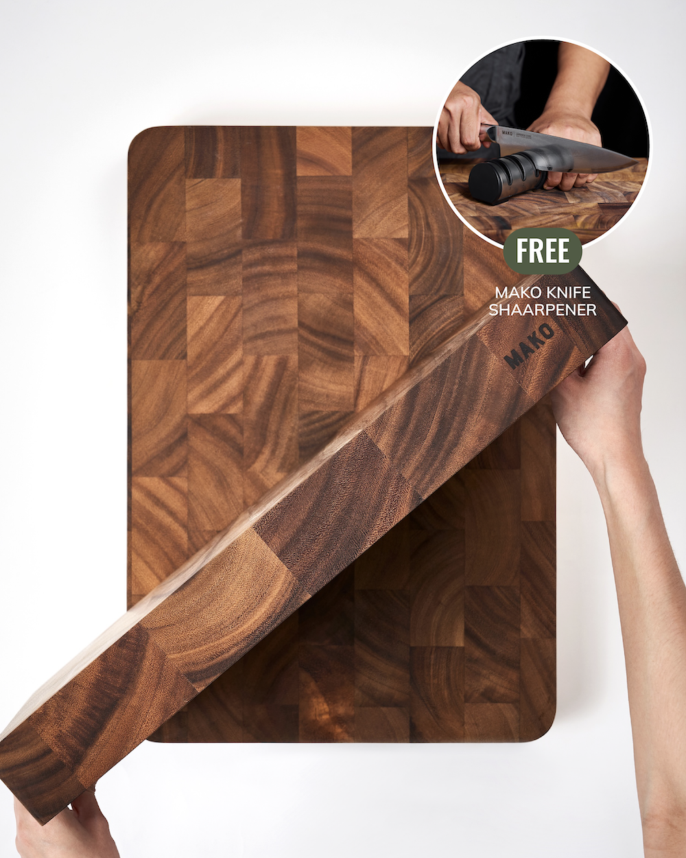A person holds a long wooden cutting board at an angle over a matching square wooden cutting board, with a circular inset showing hands sharpening a knife. Text on the inset reads 'FREE MAKO KNIFE SHARPENER'.
