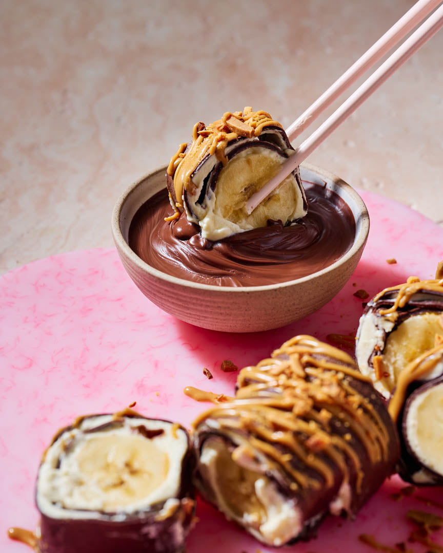 Chocolate crepe roll filled with cream, strawberries and banana