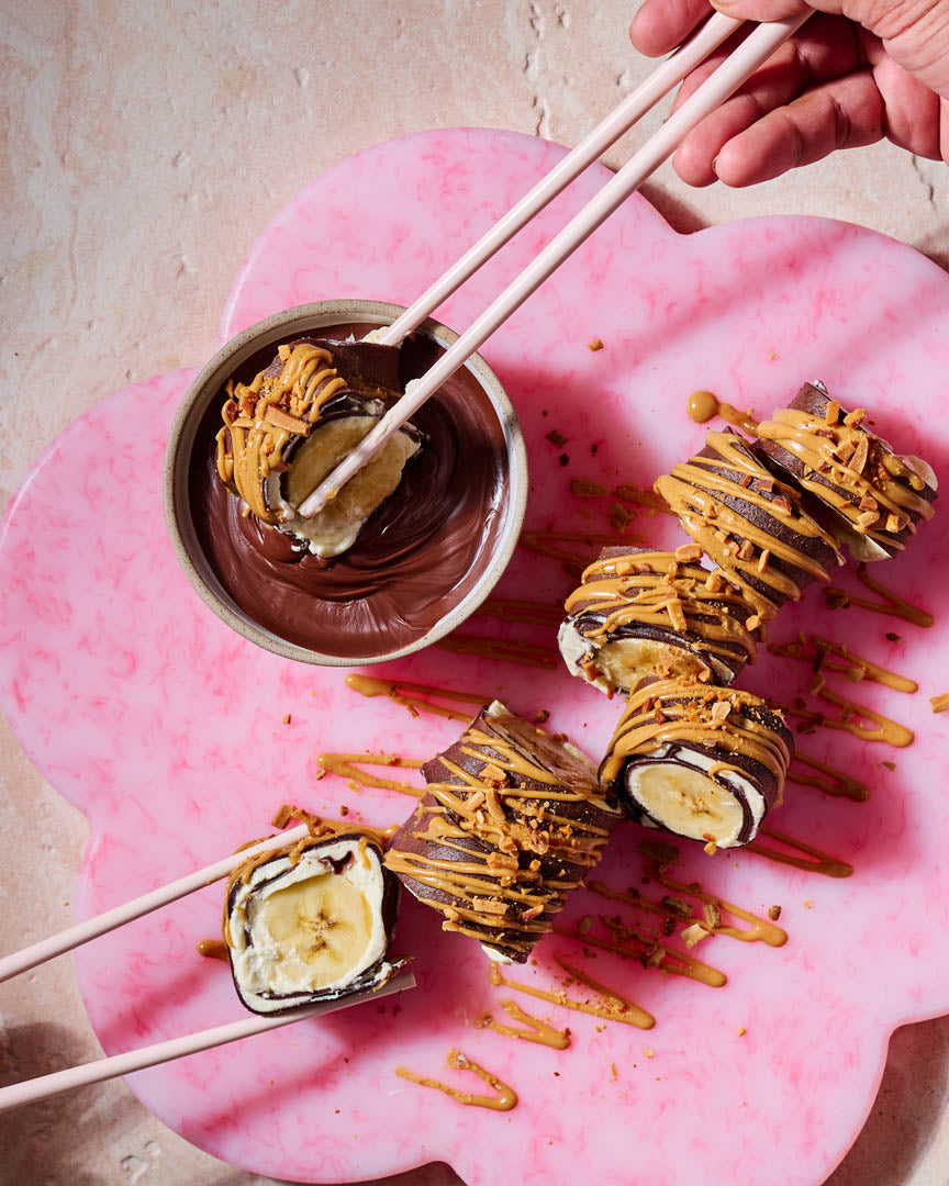 Chocolate crepe roll filled with cream, strawberries and banana