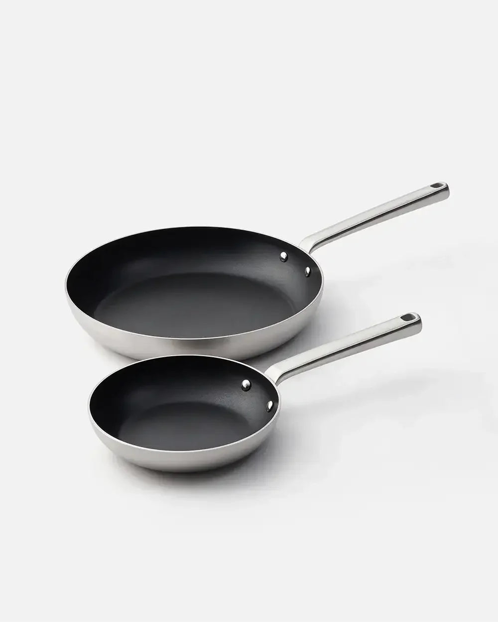 Set of two nonstick frying pans with stainless steel handles on a white background