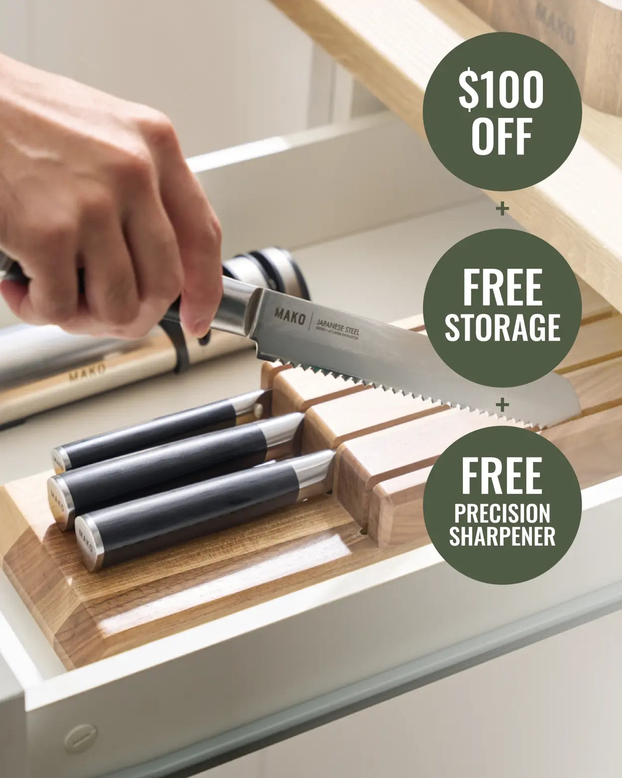 MAKO Japanese Steel Knife Set of 4 - Black In Drawer use shot of lifting bread knife out of block with sharpener by the side