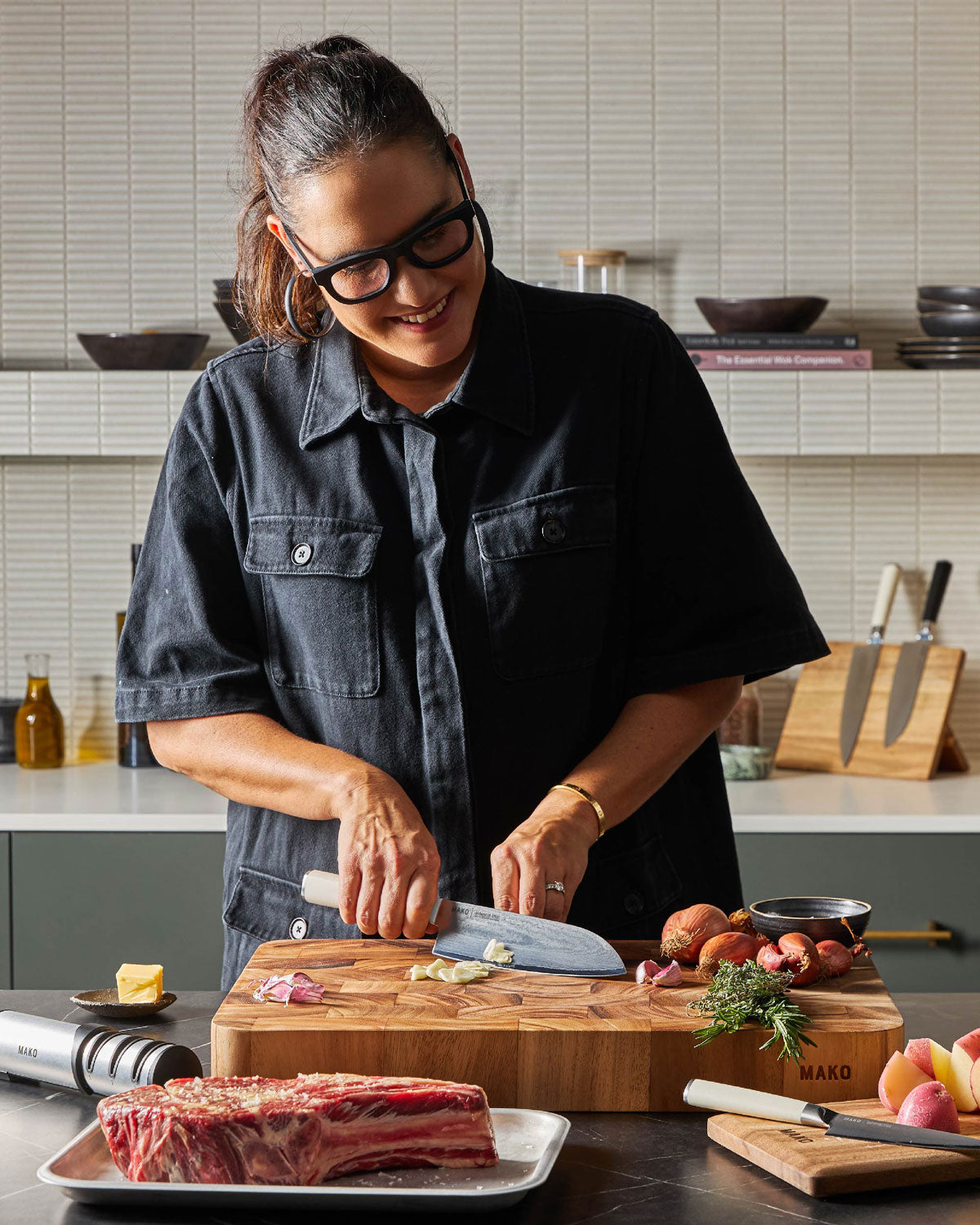 Marion chopping ingredients on a MAKO Master 20 Butcher’s Block using MAKO knives