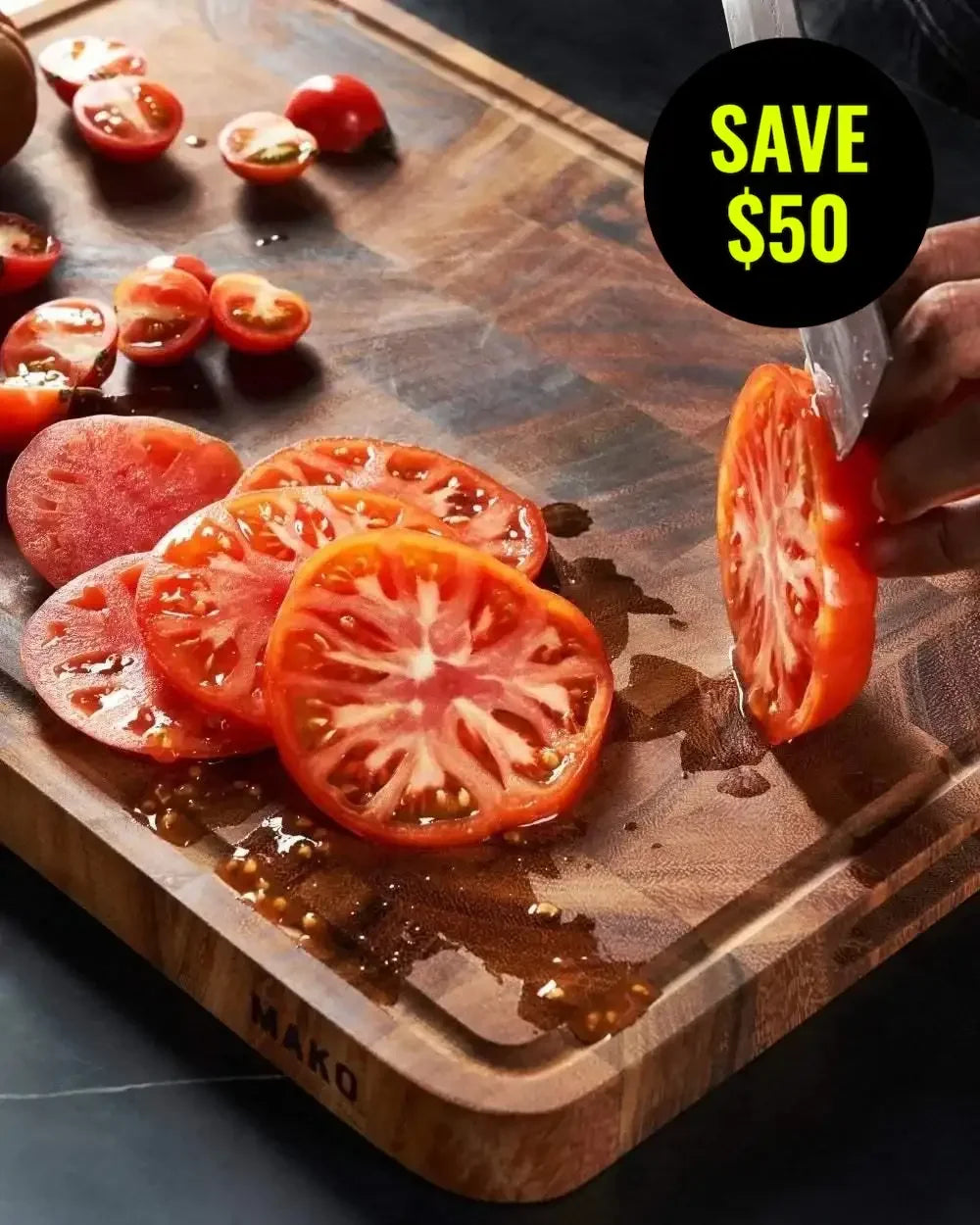 Sliced tomatoes on a wooden chopping board with a knife and save $50 offer label.
