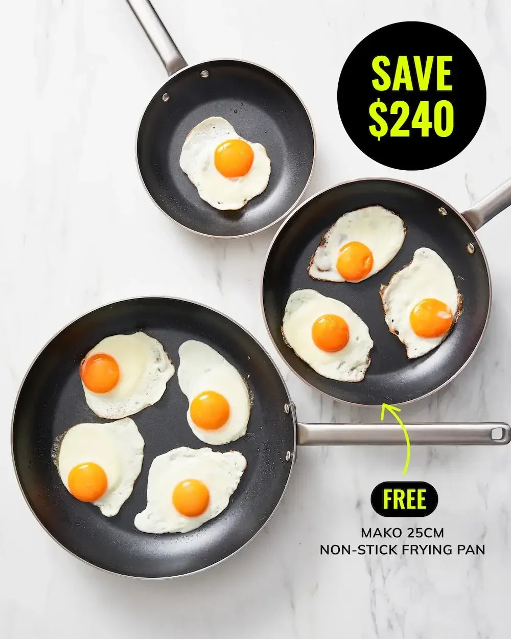 Three non-stick frying pans with cooked eggs on a marble countertop, cookware sale offer.