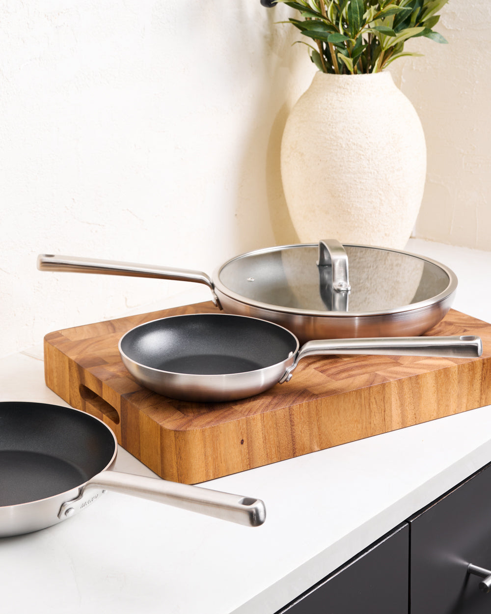 MAKO GENIUS 5-PLY NON-STICK FRYING PAN TRIO with LID - CookDineHost 3 pans on benchtop