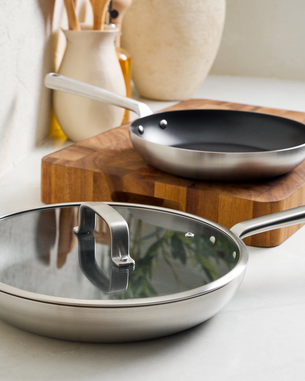 MAKO GENIUS 5-PLY NON-STICK FRYING PAN TRIO with LID - CookDineHost on benchtop in kitchen