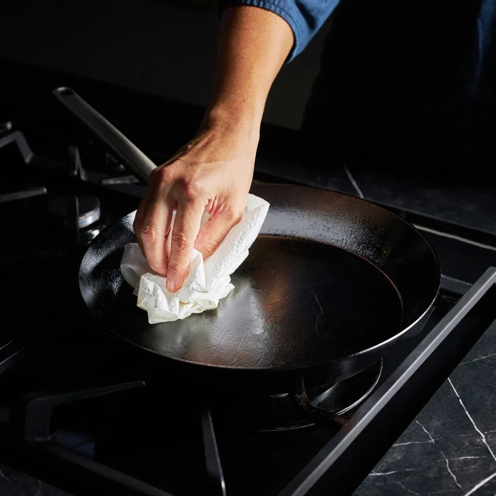 Step 5 - Use paper towel to (carefully) wipe the oil over the interior surface before taking your pan off the heat.