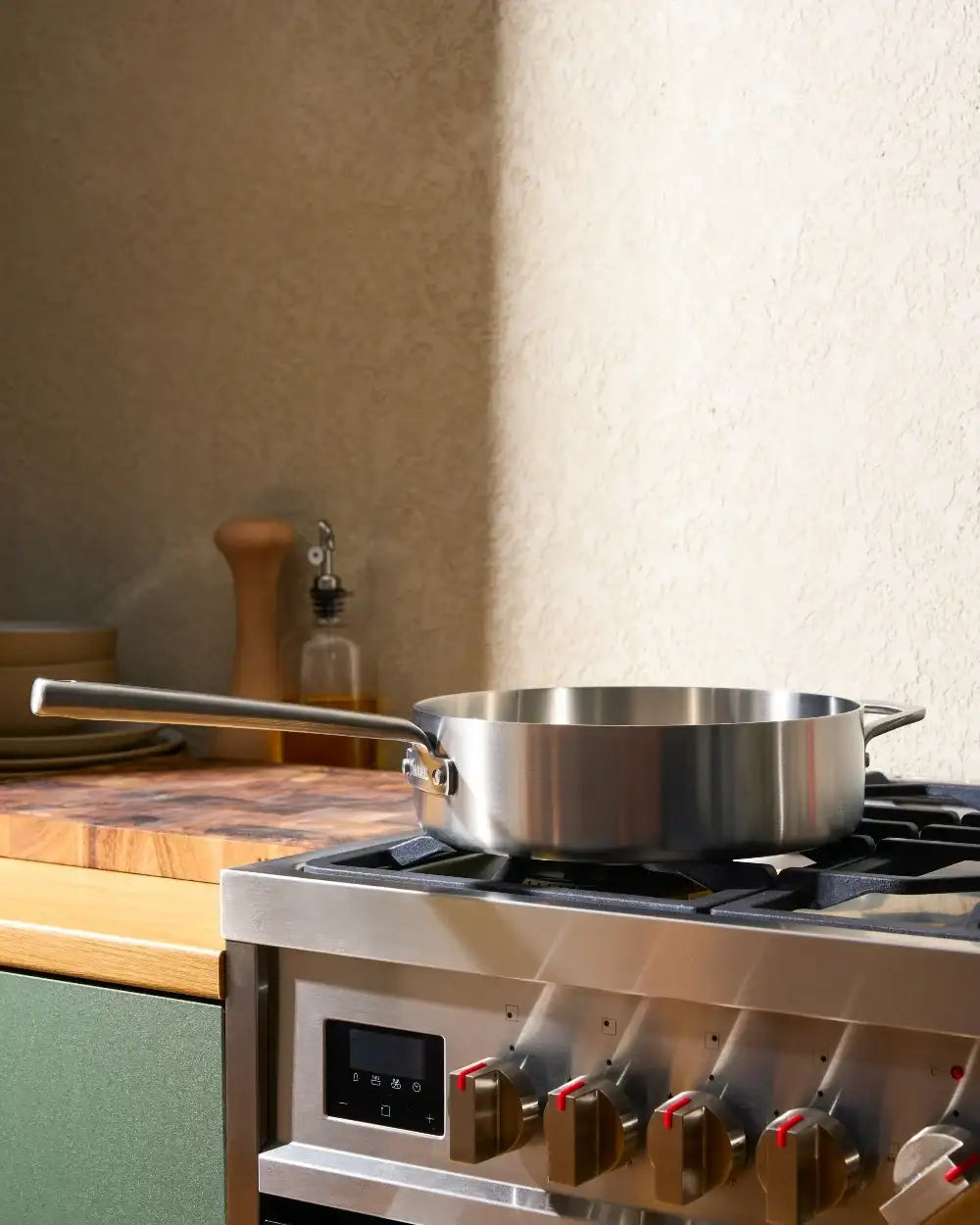 Stainless steel Mako saute pan by Marion Grasby on gas stove in sunlit kitchen