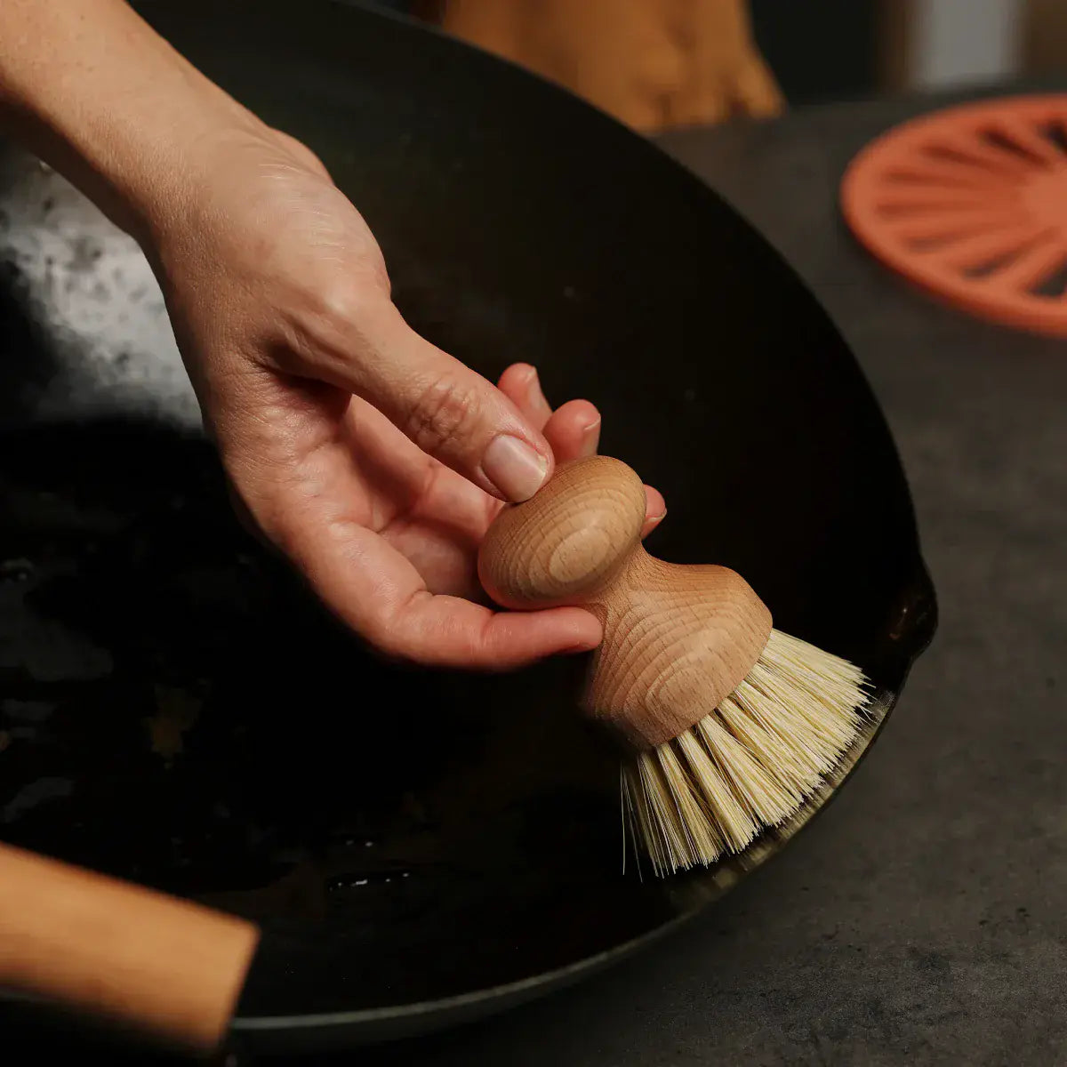 Step 1 - Let your wok cool down before cleaning with warm water, your brush and minimal detergent.