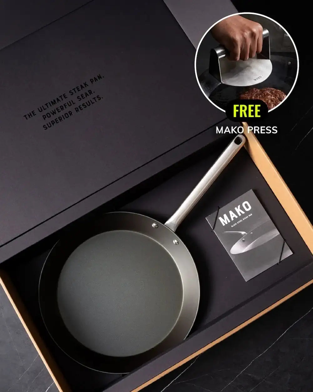 Black steel steak pan with stainless handle in gift box, includes Mako press for searing.