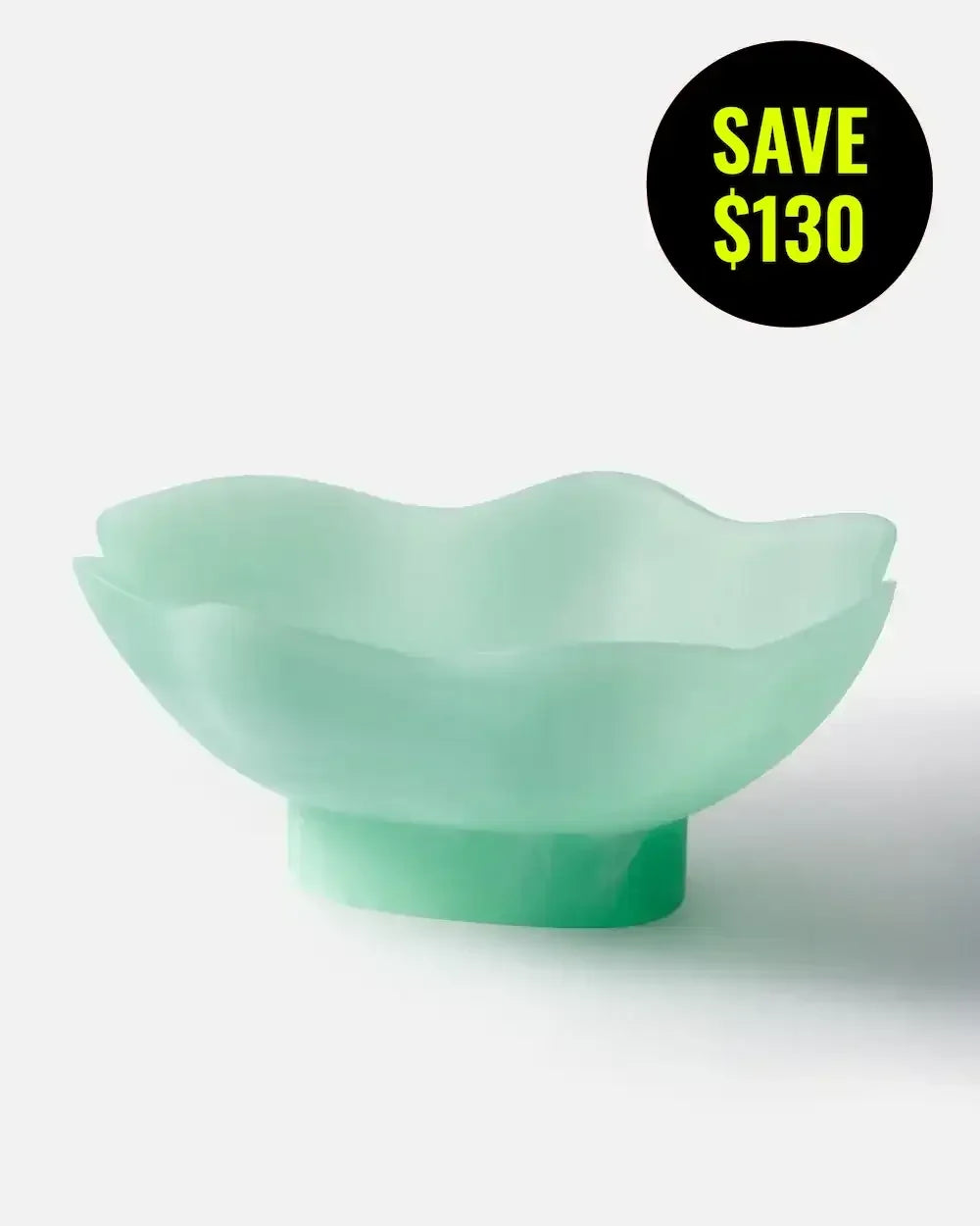 Mint green resin footed bowl with wavy rim, modern decorative homeware on white background