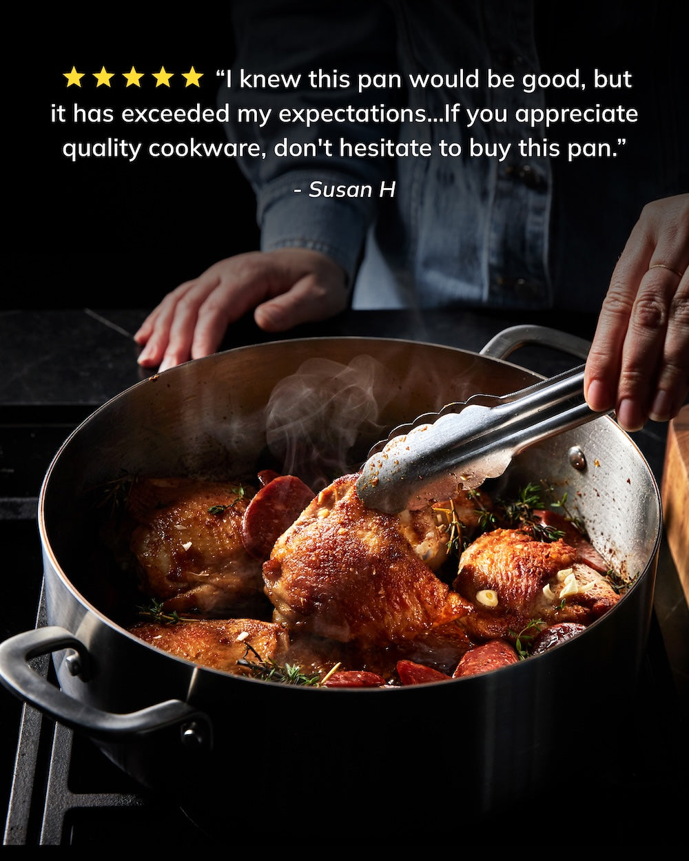 Person using tongs to cook seasoned chicken in a large stainless steel pan on a stove.