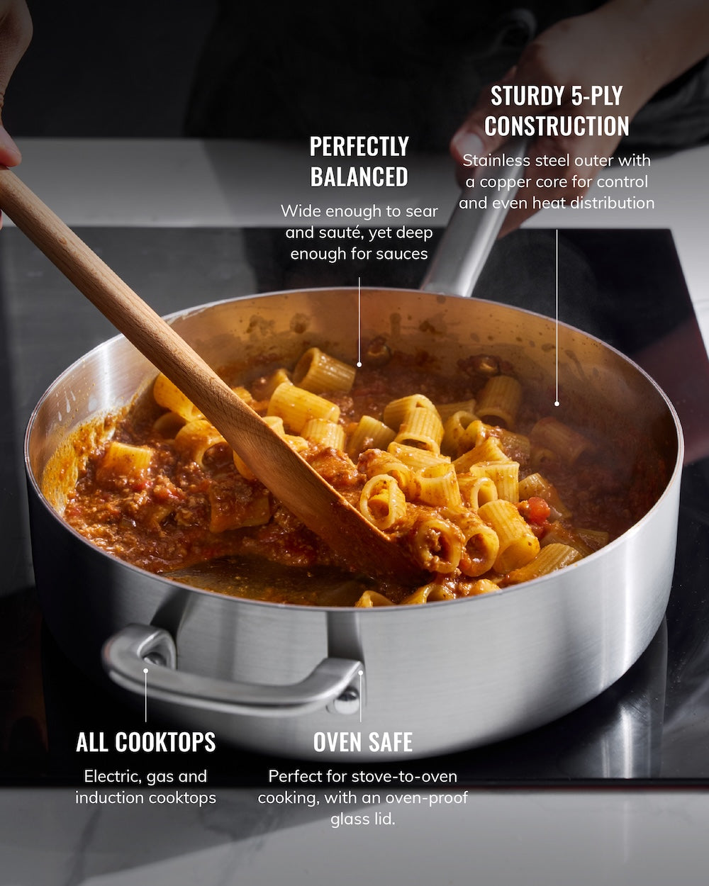 Stainless steel sauté pan with rigatoni pasta and sauce on stovetop, wooden spoon stirring, labeled features include 5-ply construction, oven safe, suitable for all cooktops.