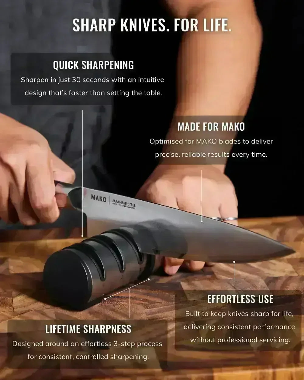 Hand sharpening a Japanese steel kitchen knife with a black knife sharpener on a wooden board.