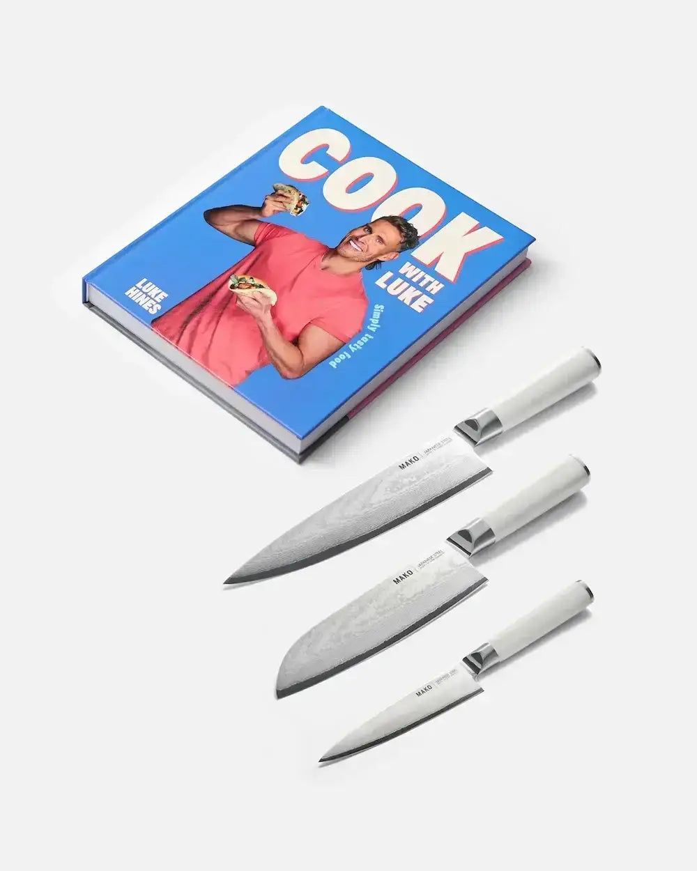 Cook with Luke cookbook by Luke Hines and set of three Mako kitchen knives with white handles on white background