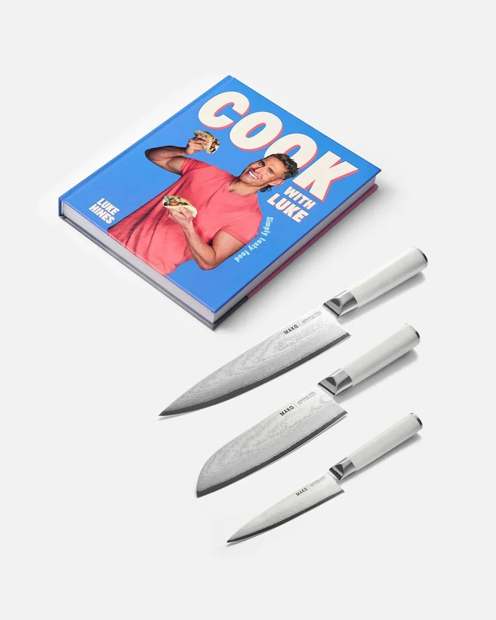 Cook with Luke cookbook by Luke Hines and set of three Mako kitchen knives with white handles on white background