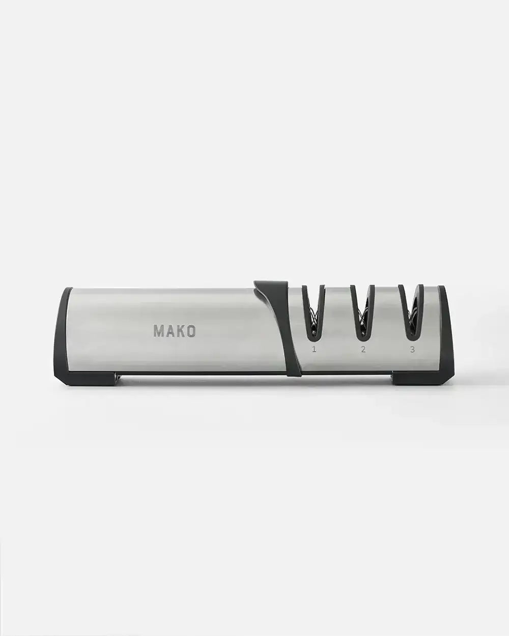 Stainless steel MAKO knife sharpener with three sharpening slots on a plain background