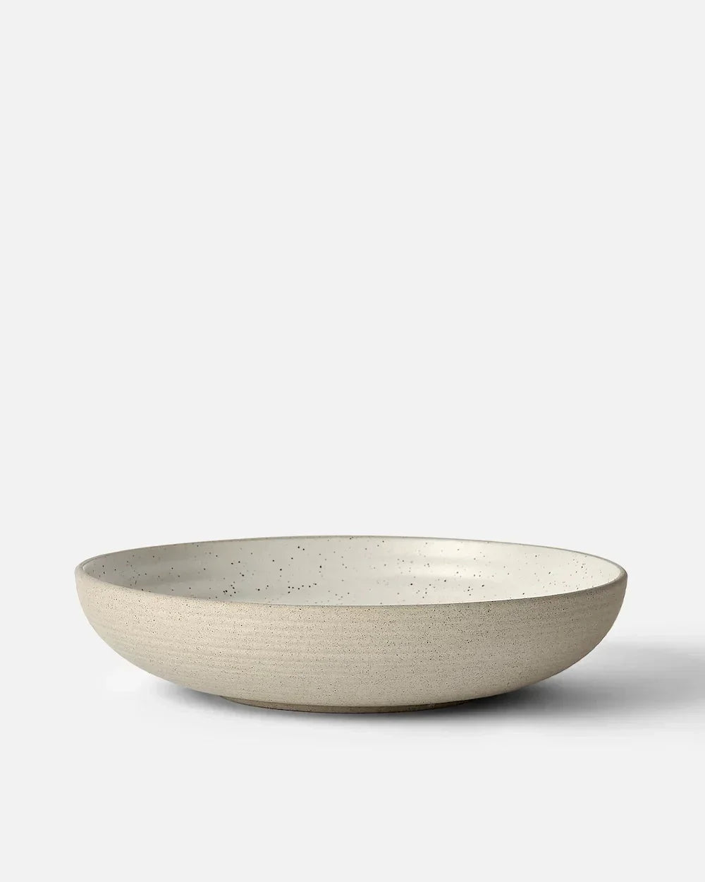 Wide, shallow beige ceramic bowl with speckled interior, minimalist design by Marion Grasby