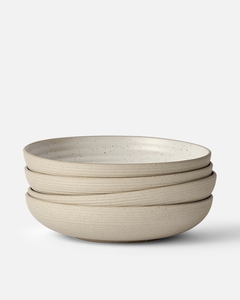 Stack of three speckled stoneware wide bowls set on a plain white background.