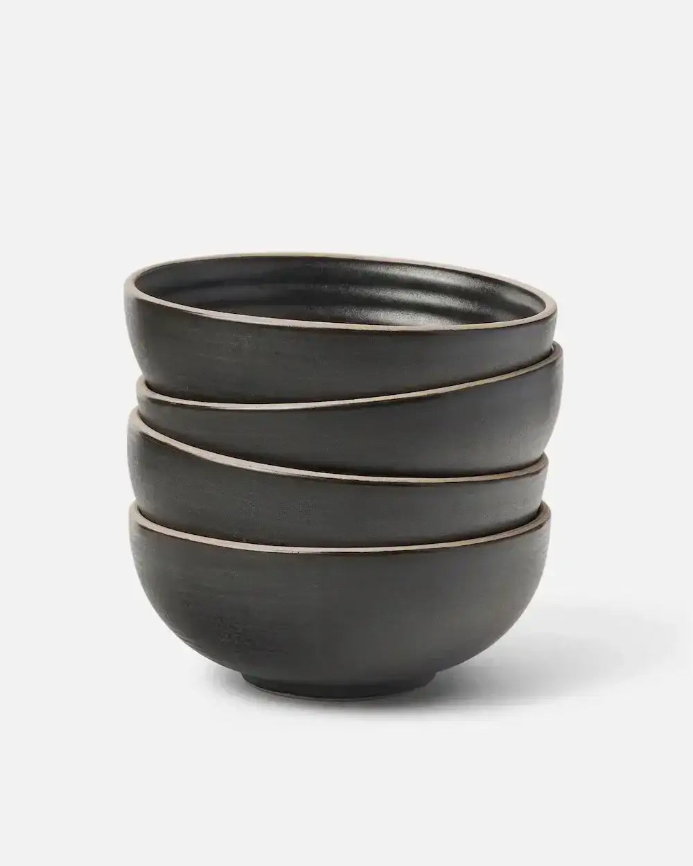 Stack of four charcoal ceramic cereal bowls by Asoke, celebrity chef Marion Grasby, on white background
