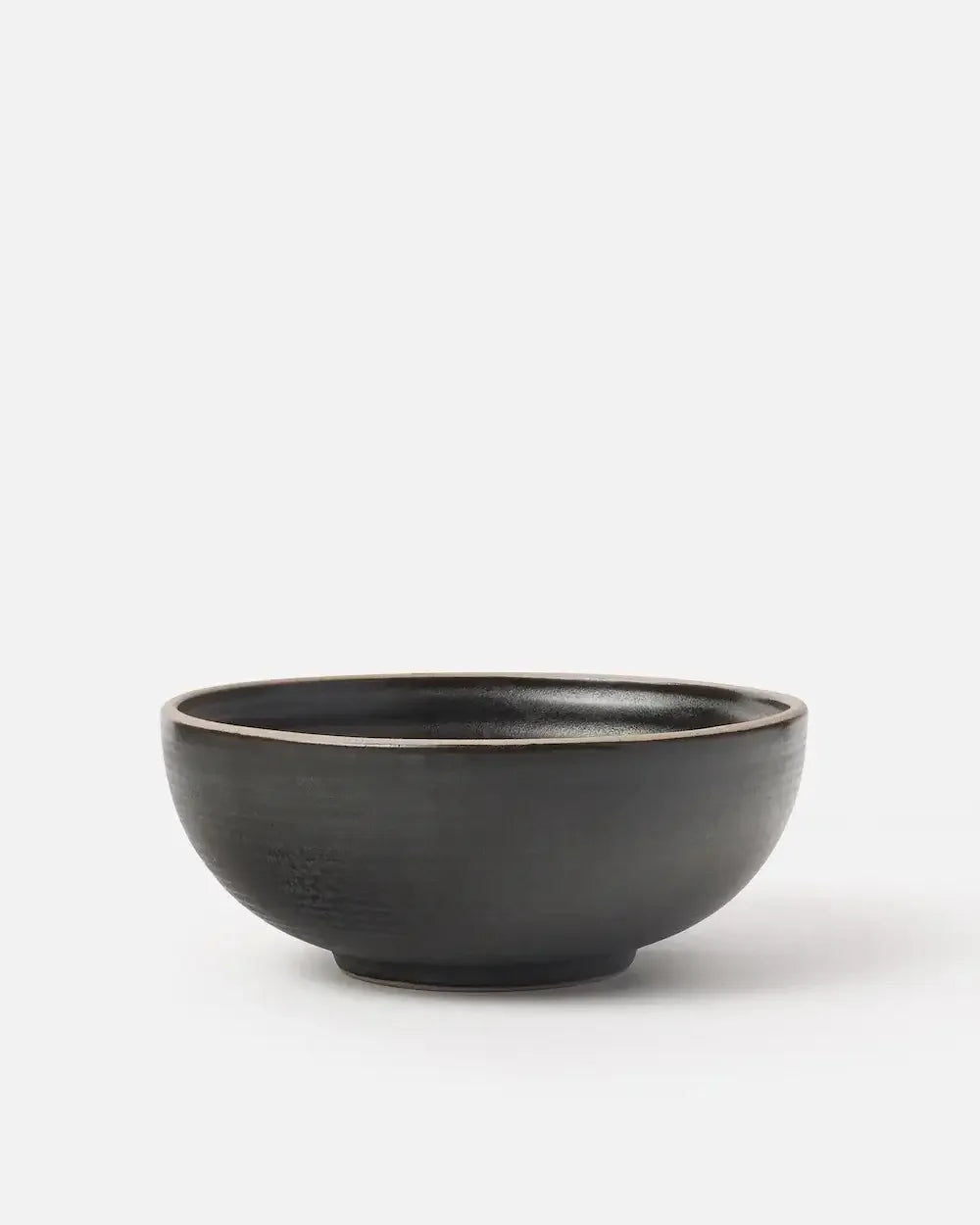 Charcoal ceramic cereal bowl with a matte finish on a plain white background