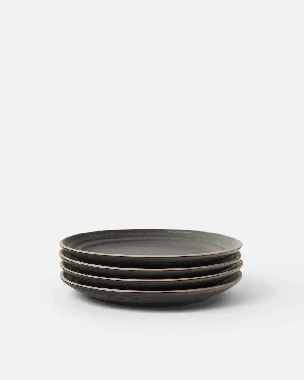 Stack of four charcoal Asoke side plates by Marion Grasby on white background
