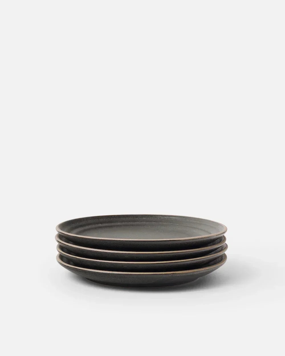 Stack of four charcoal Asoke side plates by Marion Grasby on white background
