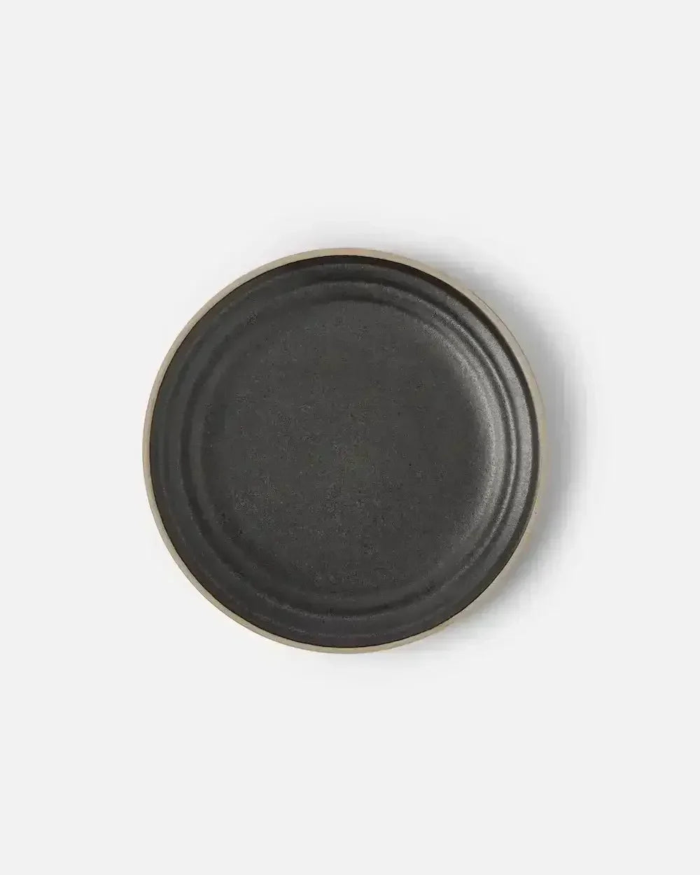 Charcoal stoneware side plate with matte finish on a light background