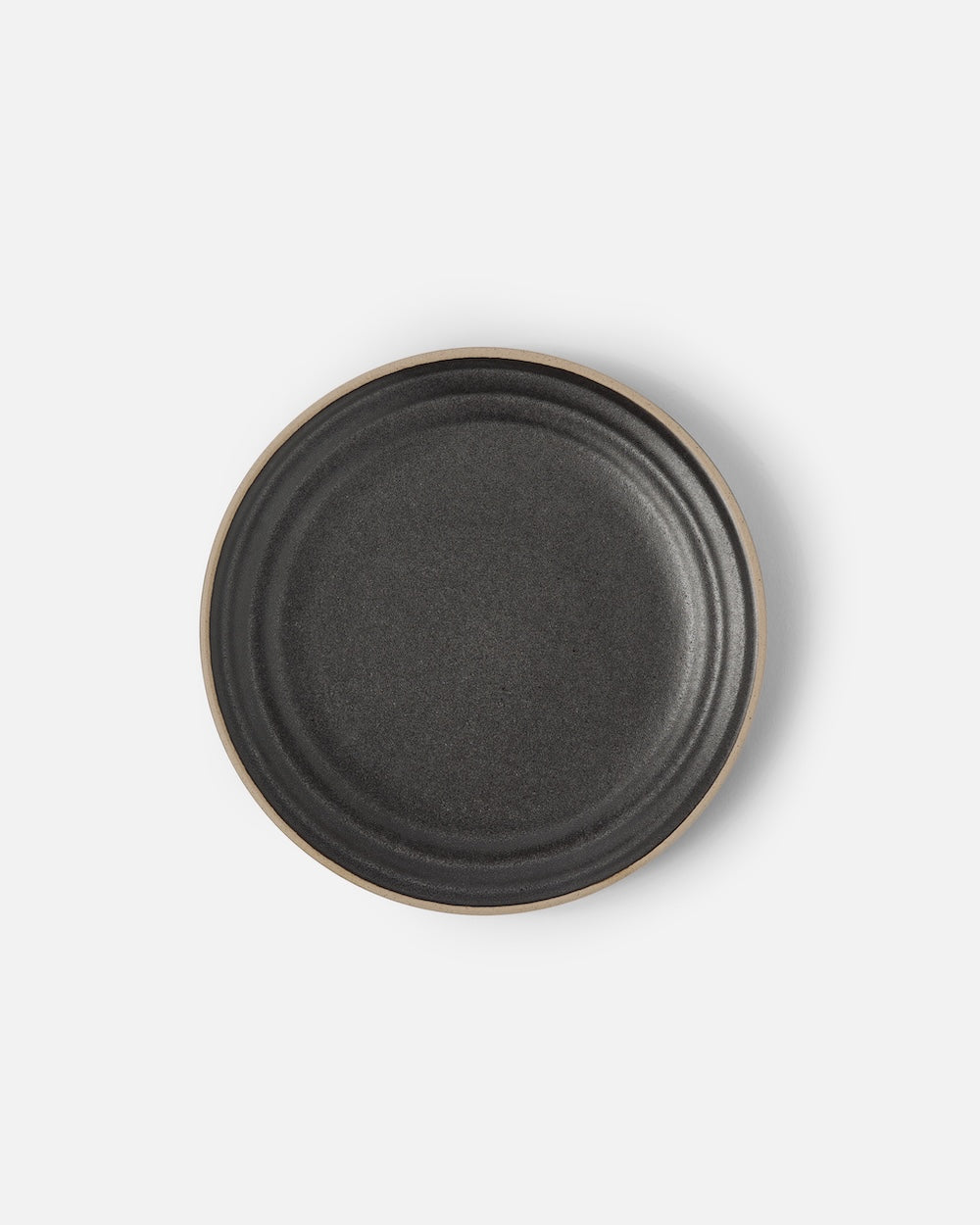 Charcoal stoneware side plate with a matte finish on a white background