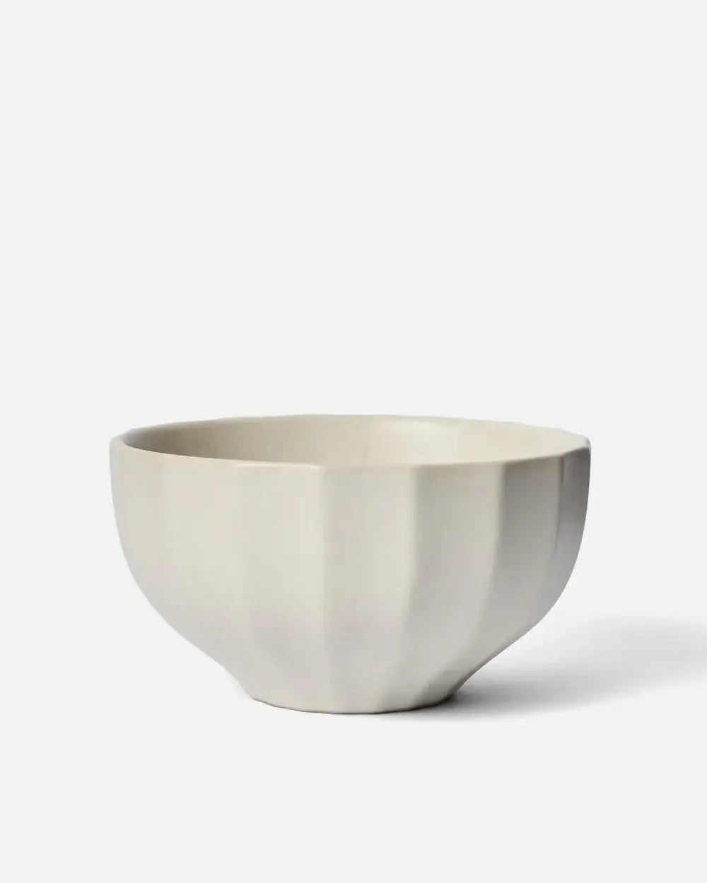 White ceramic noodle bowl with fluted exterior, minimalist design on white background