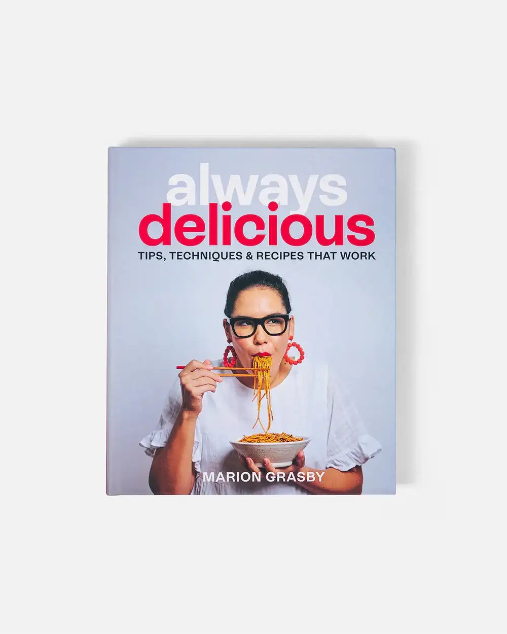 Always Delicious cookbook by Marion Grasby showing chef eating noodles with chopsticks