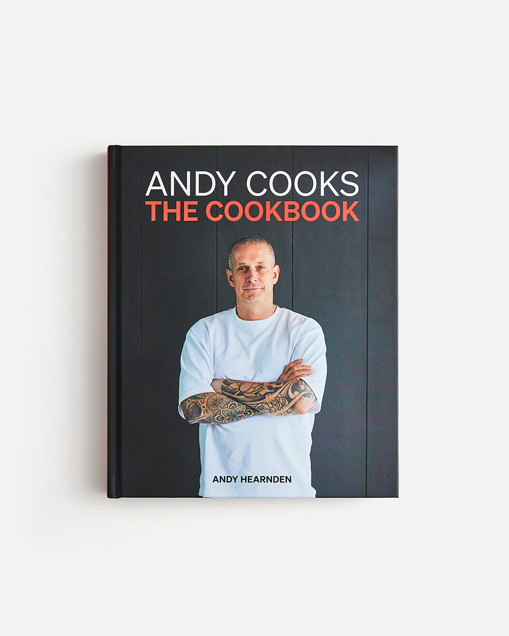 Andy Cooks cookbook by Andy Hearnden with portrait cover, tattooed chef on dark background
