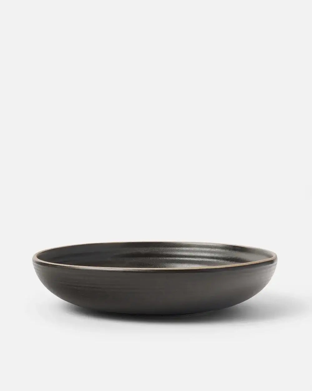 Asoke charcoal wide bowl by Marion Grasby on white background, ceramic serving dish