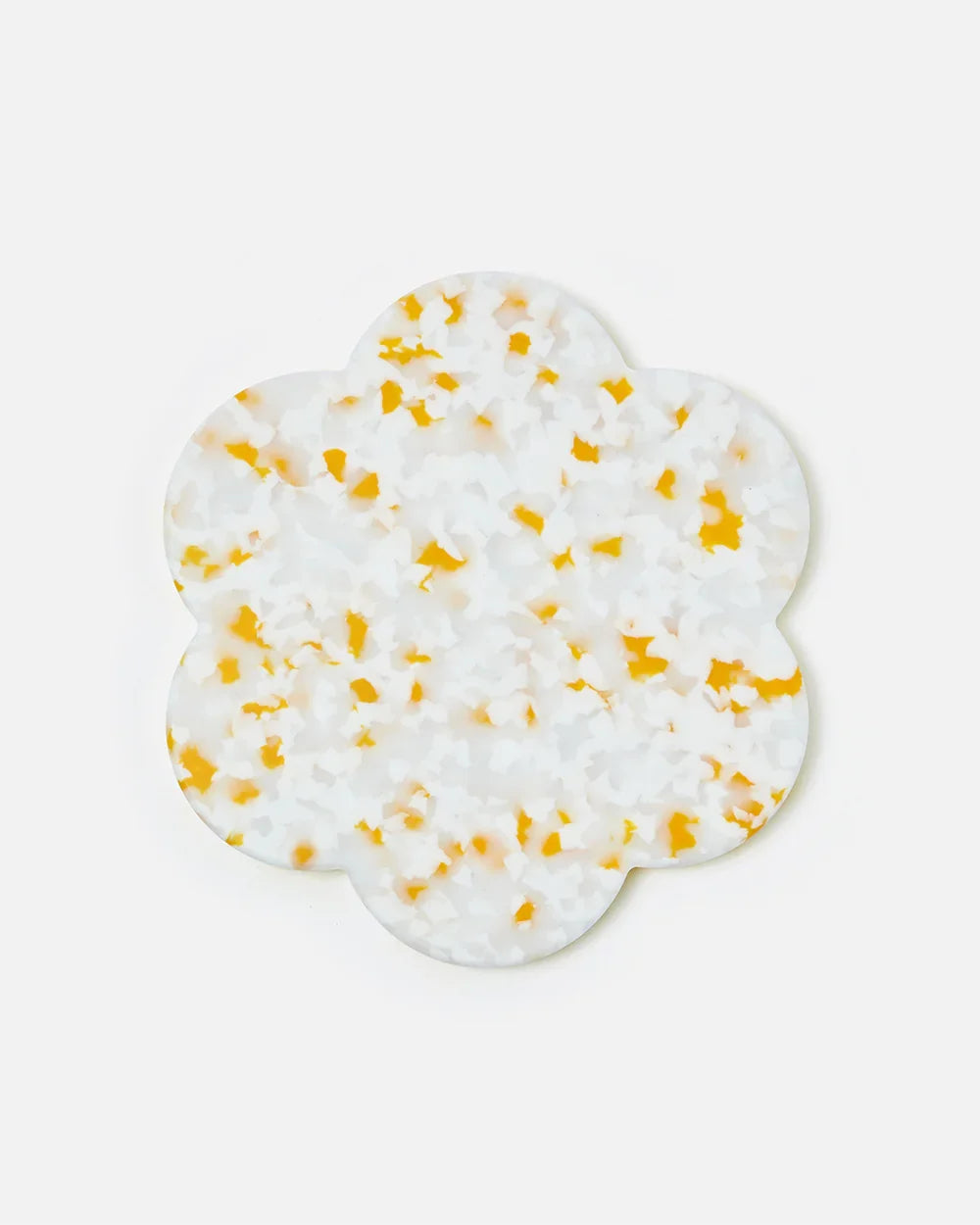 Flower-shaped terrazzo trivet with white base and yellow speckles, kitchen accessory by Marion Grasby