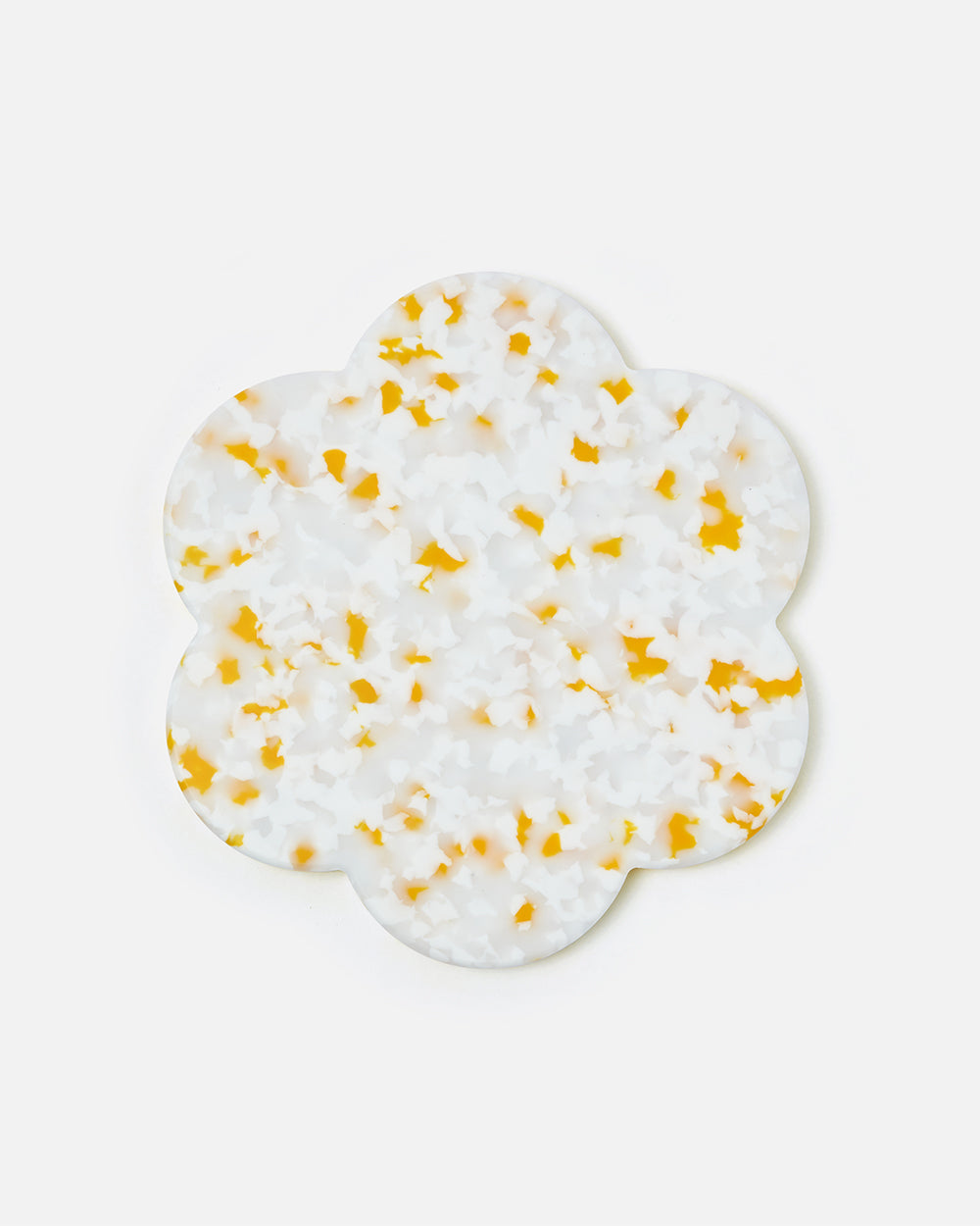Flower-shaped terrazzo coaster with white and yellow pattern on white background