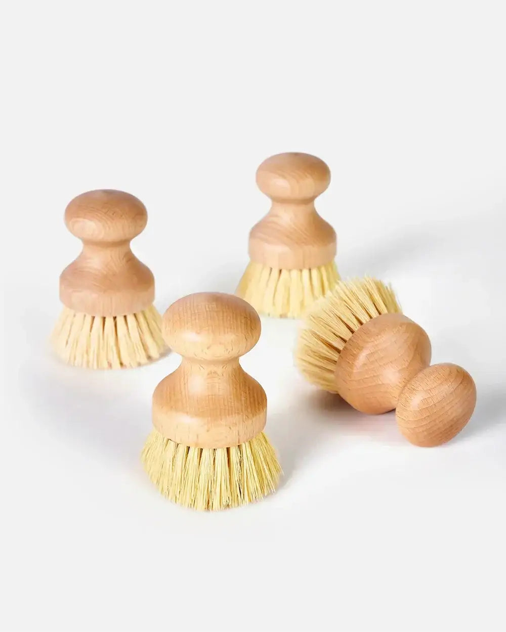 Set of four wooden dish scrub brushes with natural bristles on white background