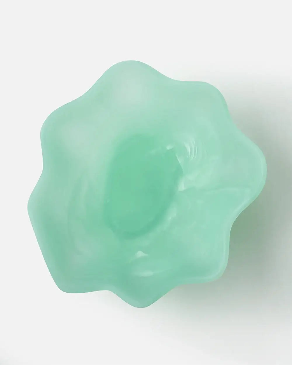 Mint green flower-shaped footed glass bowl on white background, kitchenware by Marion Grasby