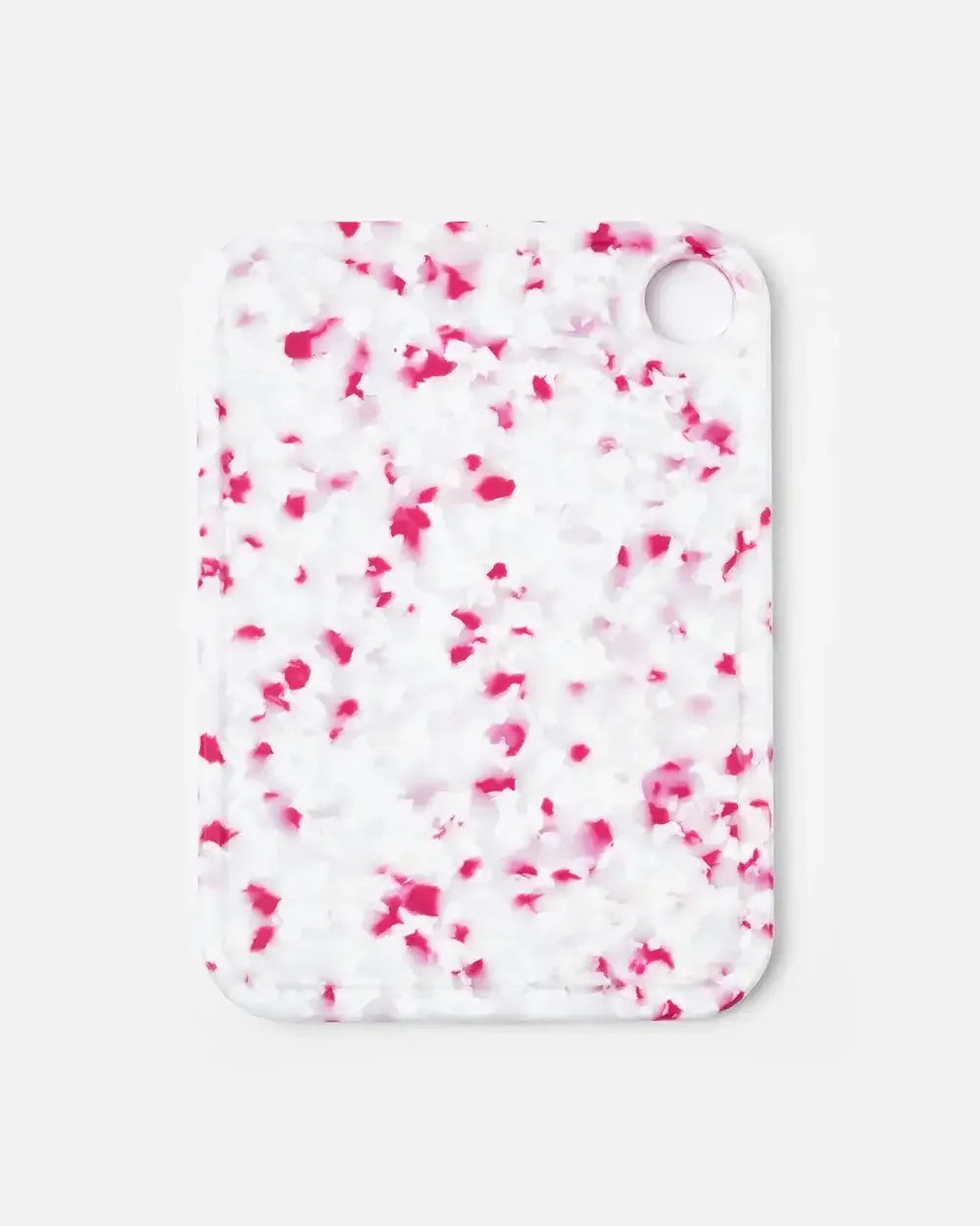 Rectangular cutting board with pink and white speckled pattern and rounded edges