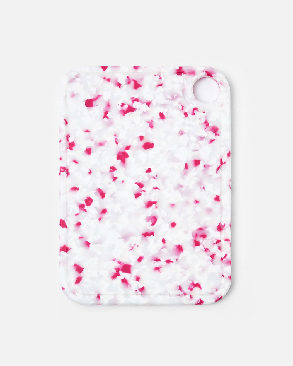 Rectangular cutting board with pink and white speckled pattern and rounded edges