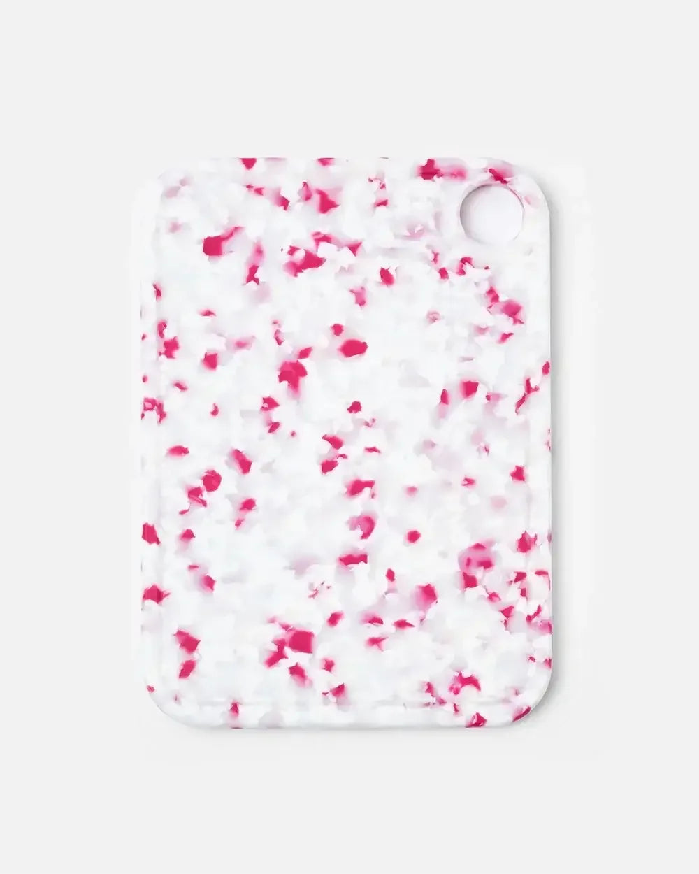 Rectangular cutting board with white and pink speckled pattern and rounded corners