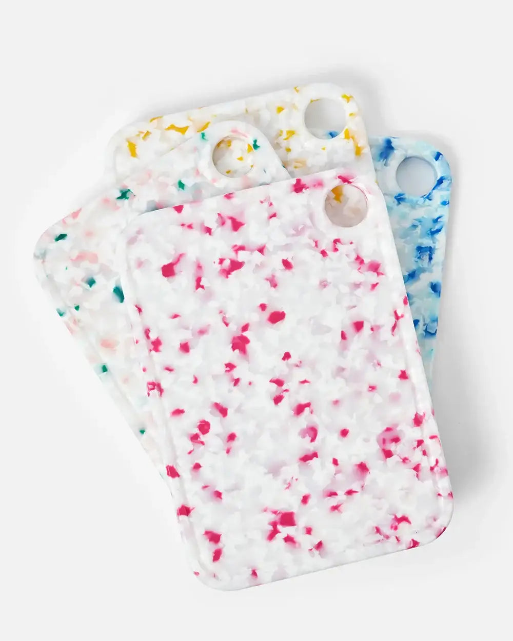 Set of three terrazzo-patterned cutting boards in white with pink, yellow, and blue accents