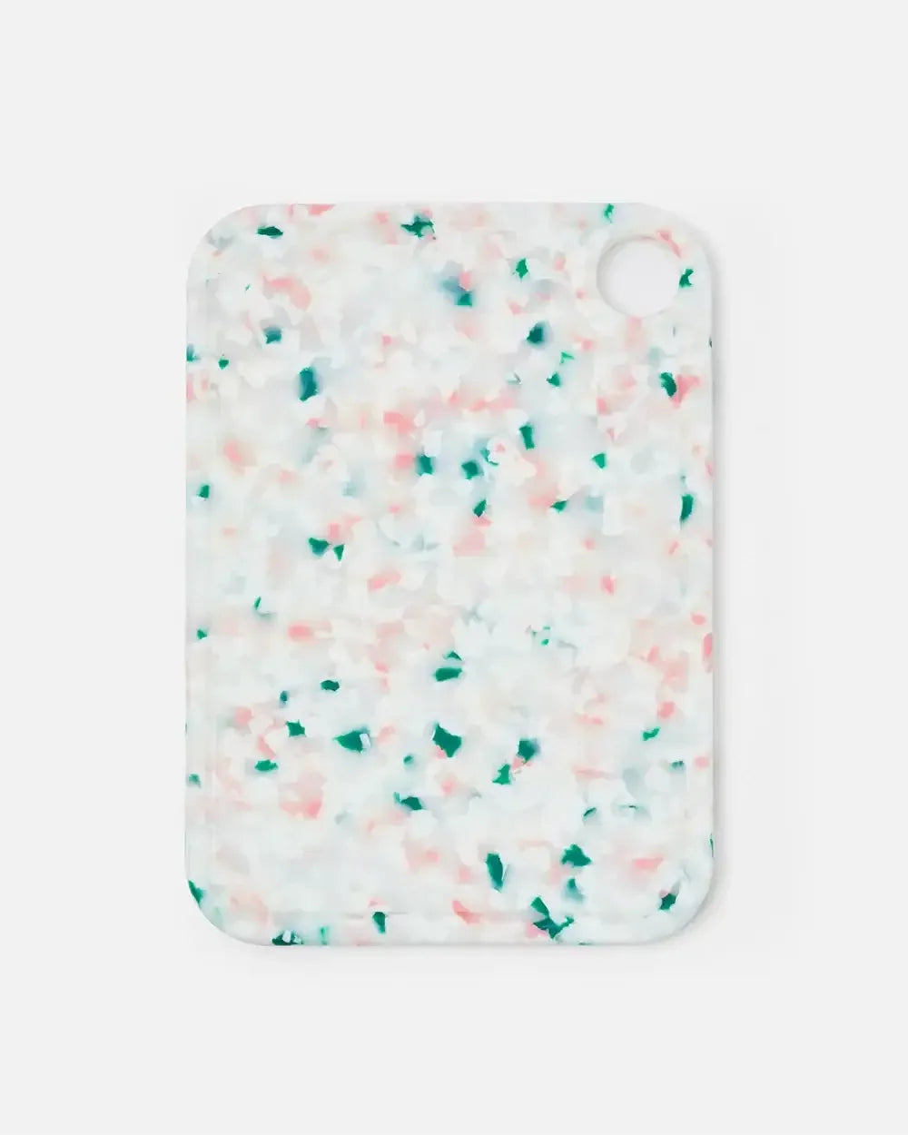 Rectangular speckled cutting board with pink and green accents on white background