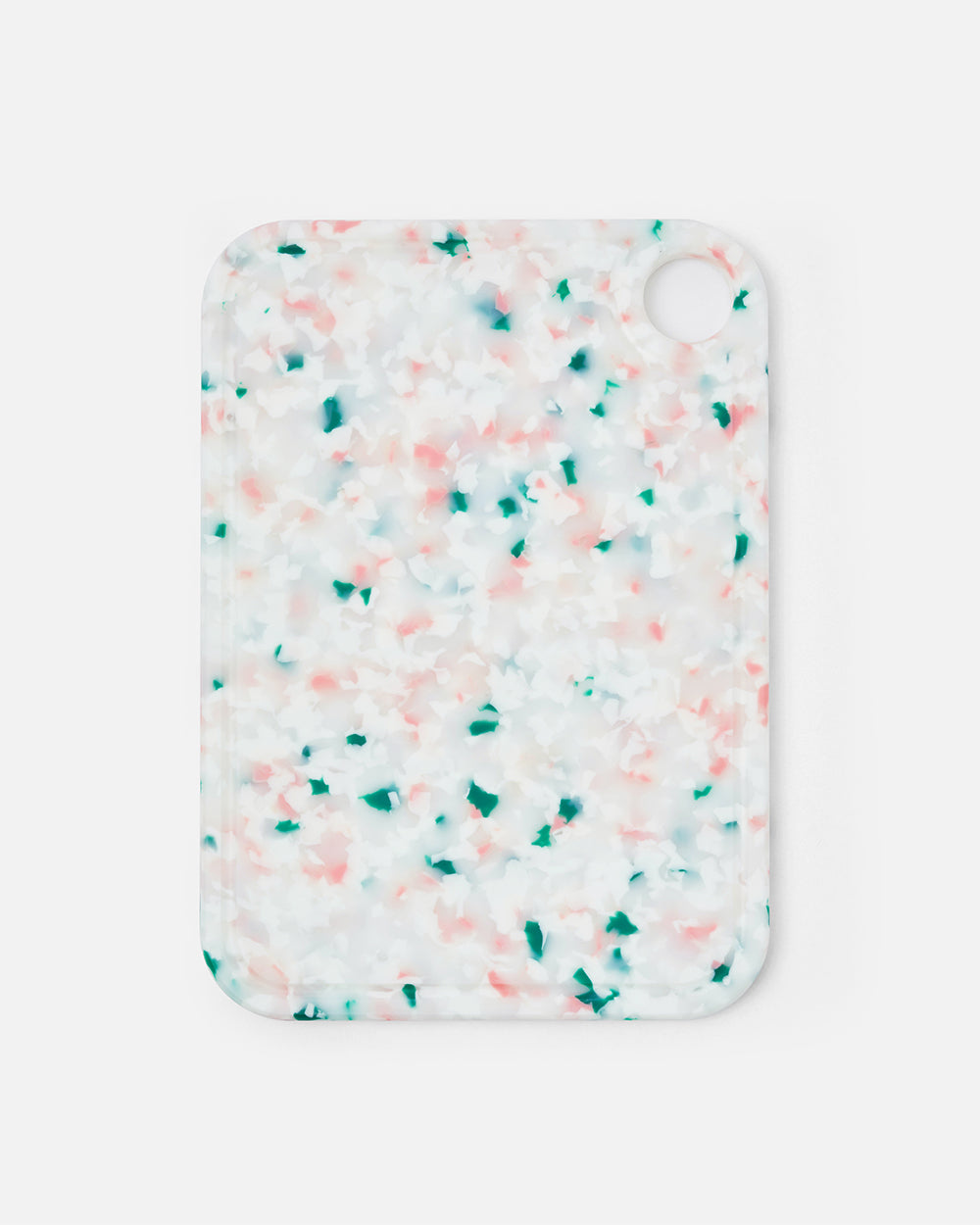 Rectangular speckled cutting board with pink and green accents on white background