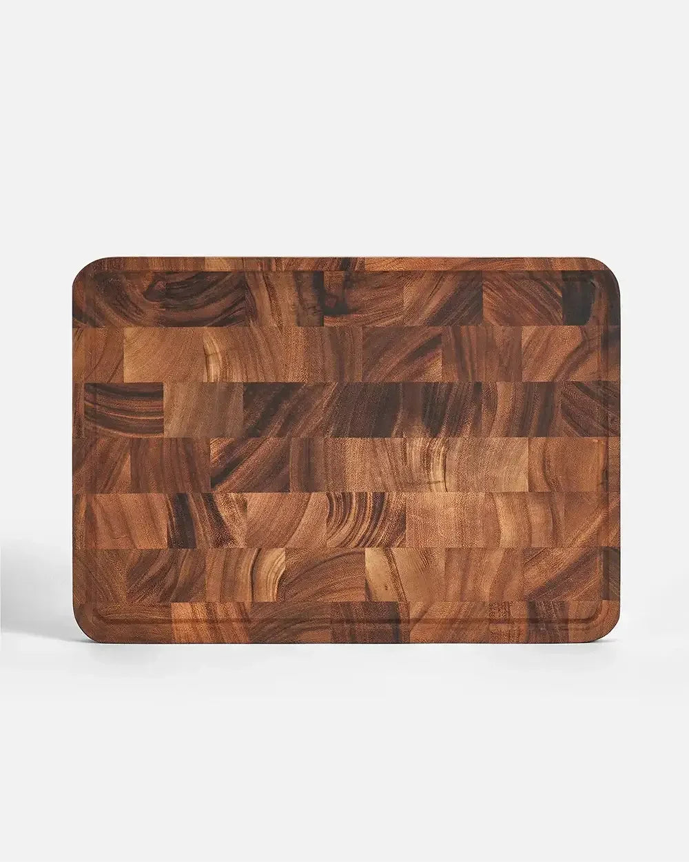 Rectangular end grain wooden chopping board with juice groove on white background