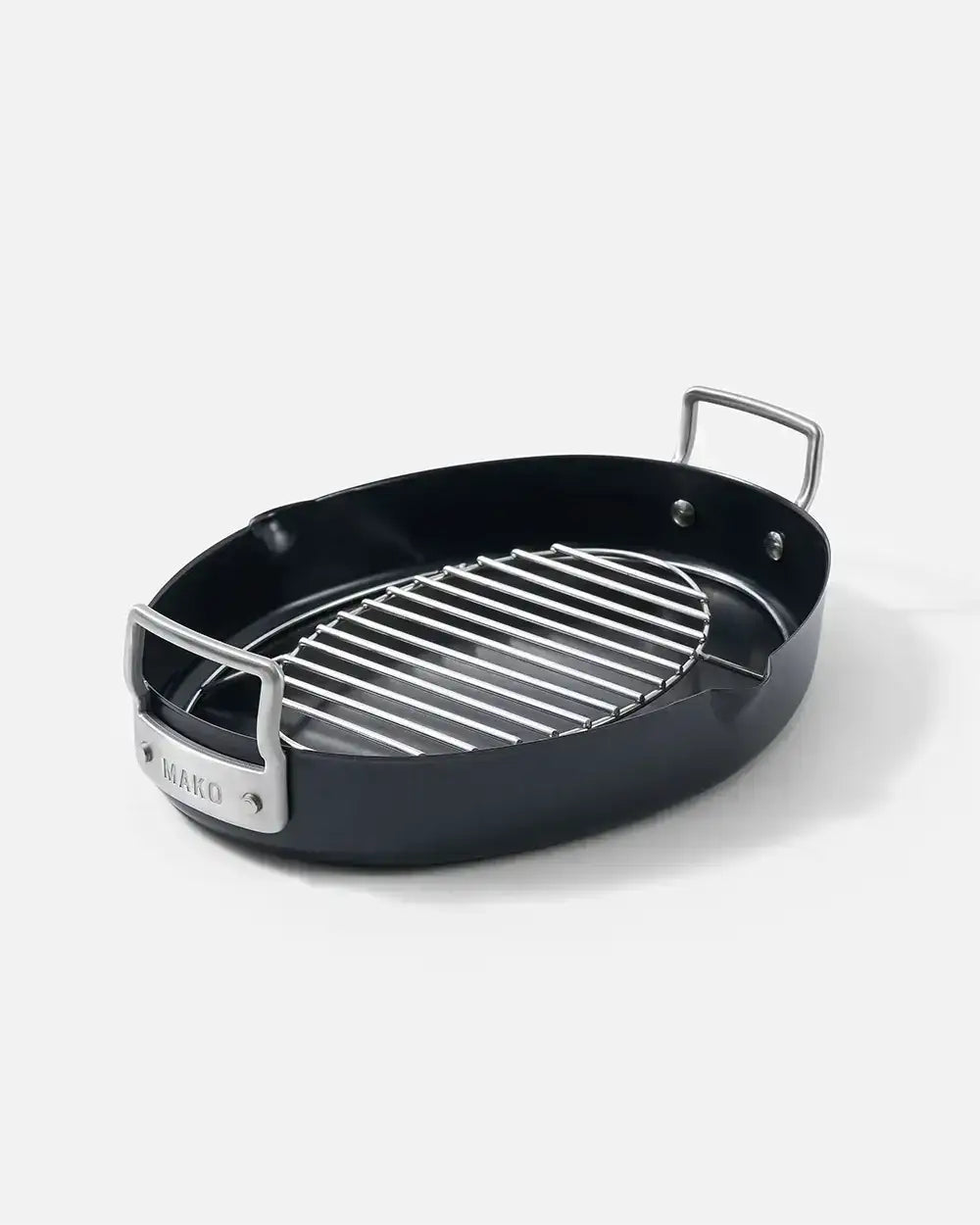 Black oval Mako roasting pan with stainless steel handles and removable grill rack by Marion Grasby