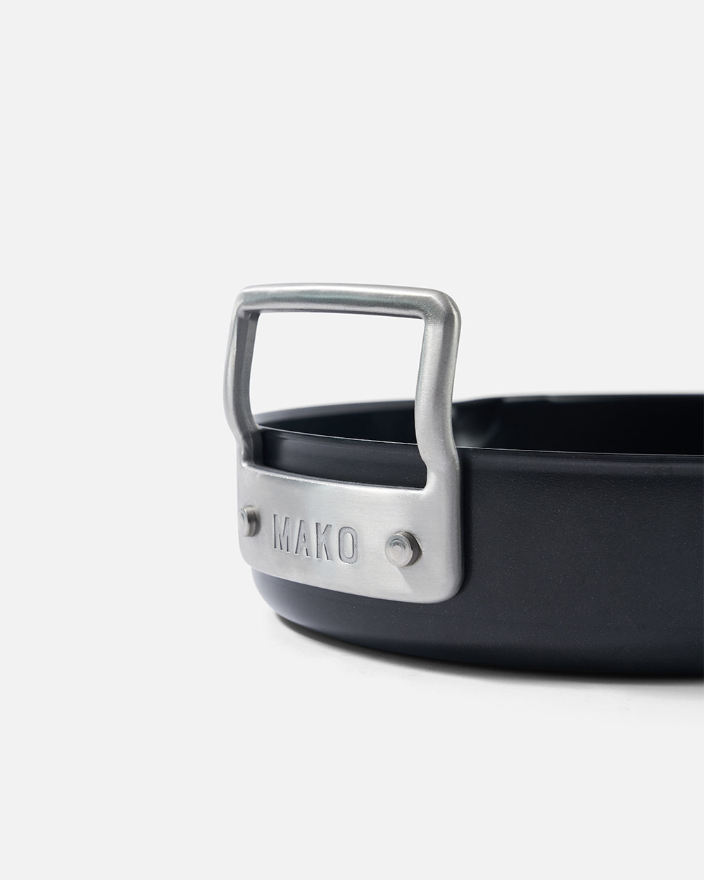 Close-up of MAKO nonstick cookware metal handle against white background