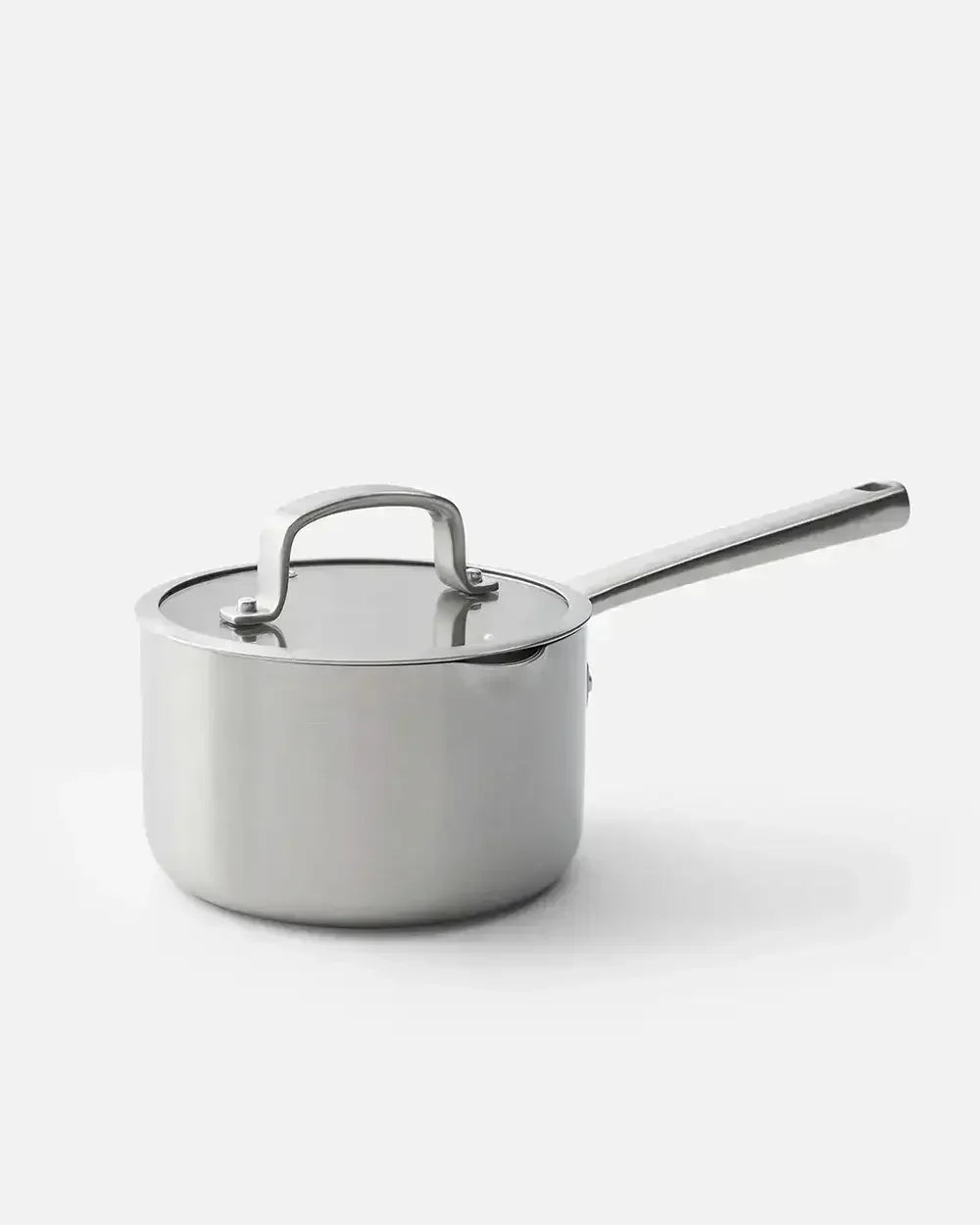 Stainless steel saucepan with lid and long handle on white background